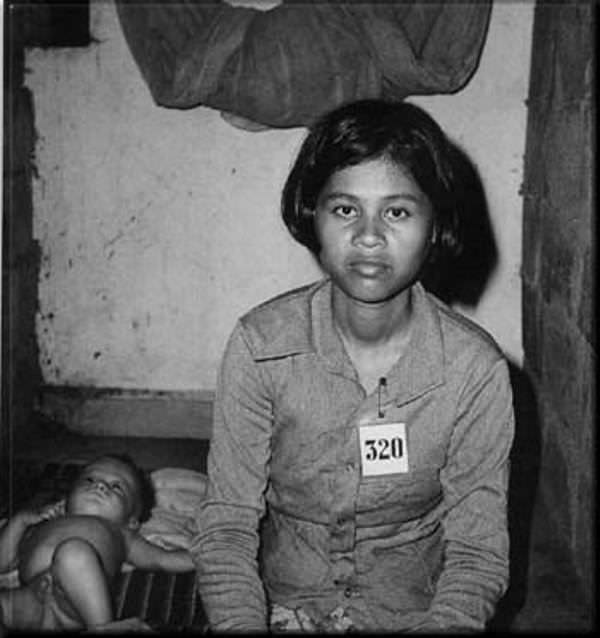 A young girl with her baby in the prison.