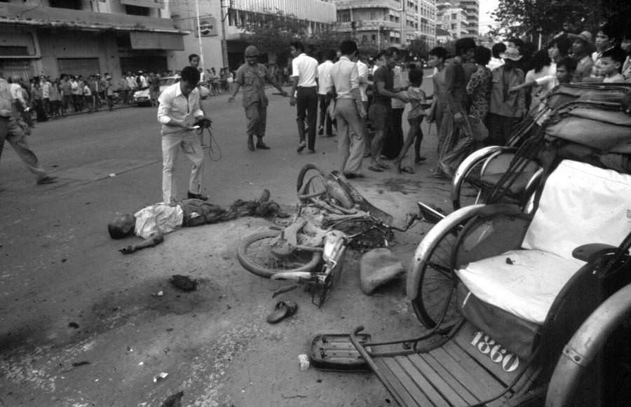 Tömeg gyűlik össze egy polgár körül, amelyet Phnom Penh khmer ruha ölt meg.  1975.