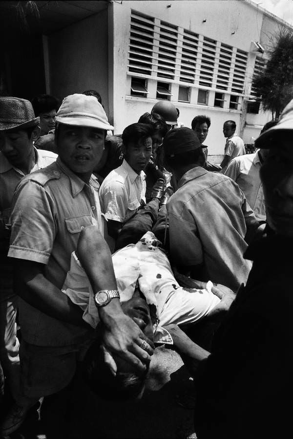 Cambodians helping an injured civilian, Phnom Penh, 1975.