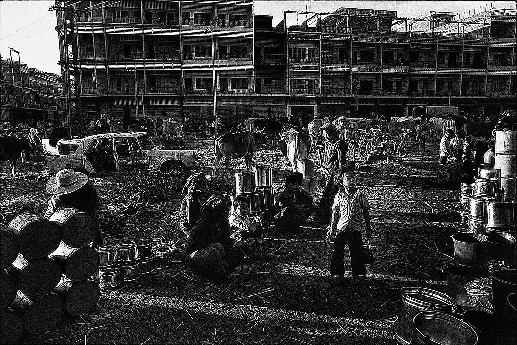 The Fall of Phnom Penh. A group of people who found shelter next to an abandoned market area in the city center.