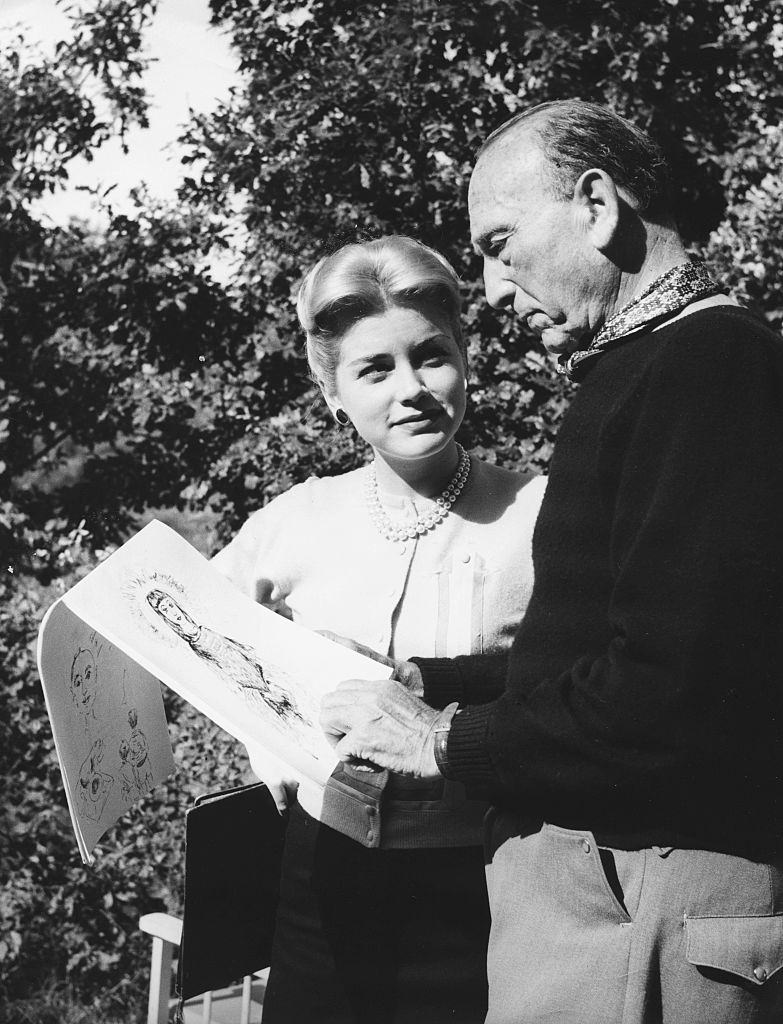 Dolores Hart with director Michael Curtiz, looking at her sketches on the set of the film 'Francis of Assisi', 1961