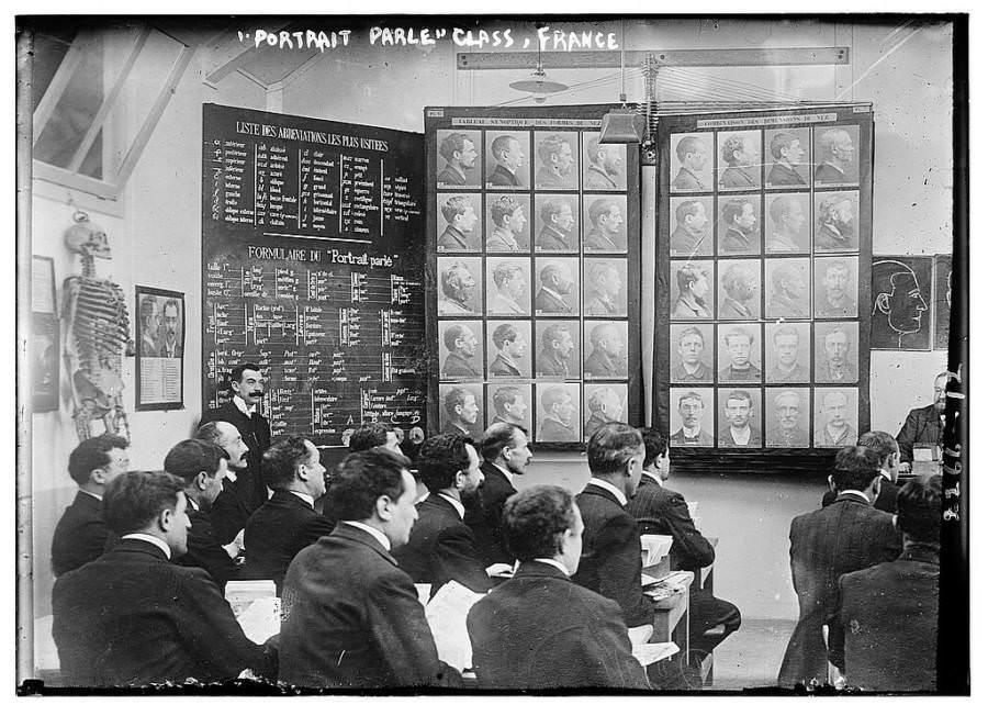 A class studies the Bertillon method of criminal identification, based on measuring body parts in France, 1910s