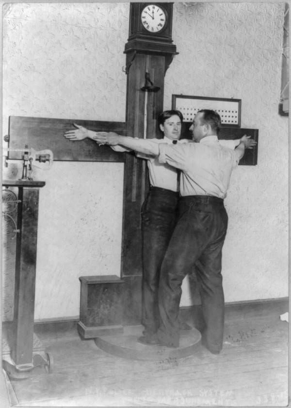 The New York City Police Department practices taking arm measurements using anthropometric methods, New York, 1908