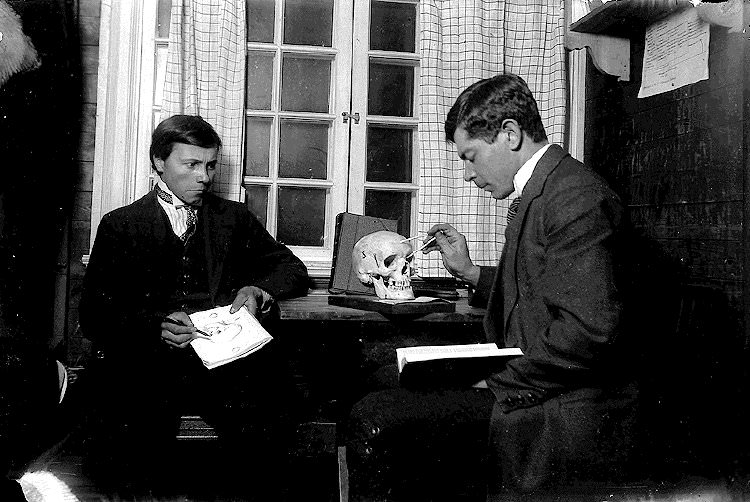 A craniologist demonstrates how to measure a human skull, Sweden, 1915
