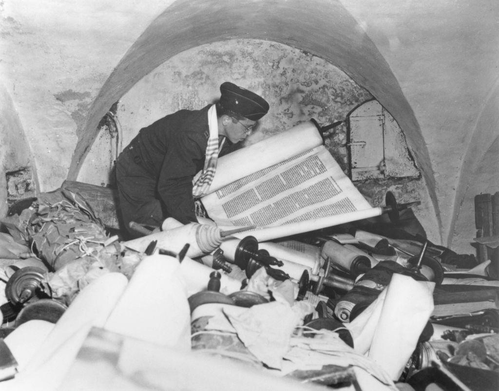 US Army chaplain Samuel Blinder examines one of hundreds of Jewish Sefer Torah scrolls, stolen from all over Europe by Nazi forces.