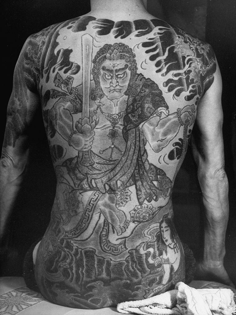 Tattoo representing God of Sun, Fire and Water on back of Japanese gambler, 1946