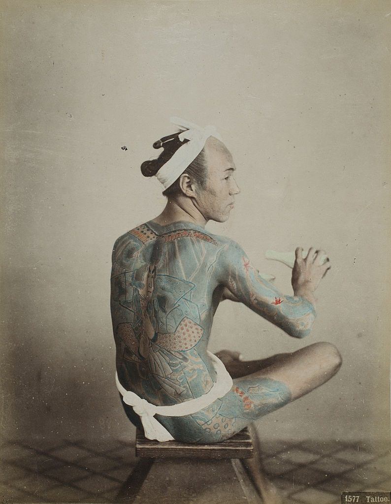 Japanese Tattoo man tattooing himself, 1880s