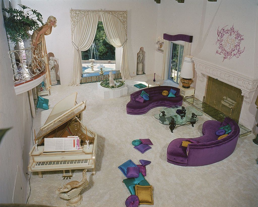 Jayne Mansfield on balcony above the garish, shag carpet covered living room of her, Pink Palace, 1960s