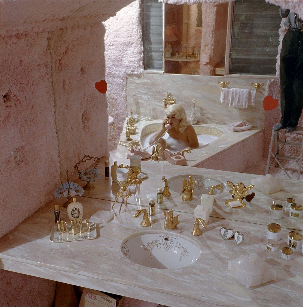 Jayne Mansfield uses the telephone in her furry pink bathroom of Pink Palace, 1960s