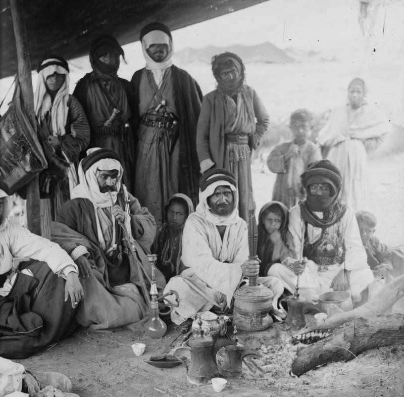 A group of Bedouins prepare coffee in a tent, 1936