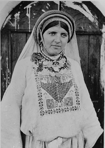 A woman, labelled, in the original caption, as a "peasant girl, "Circa 1900-1920