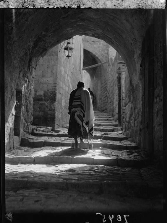 A man walks down the streets in the Jewish quarters, Circa 1920-1933
