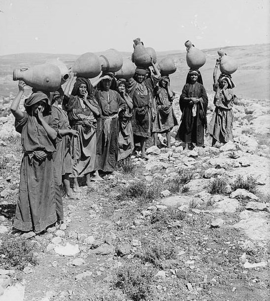 A group of women carrying water jars on their heads, Circa 1900-1920