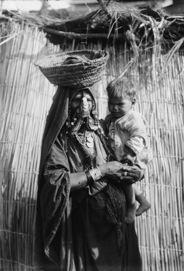 A mother carries her baby.Beersheba, Circa 1900-1920