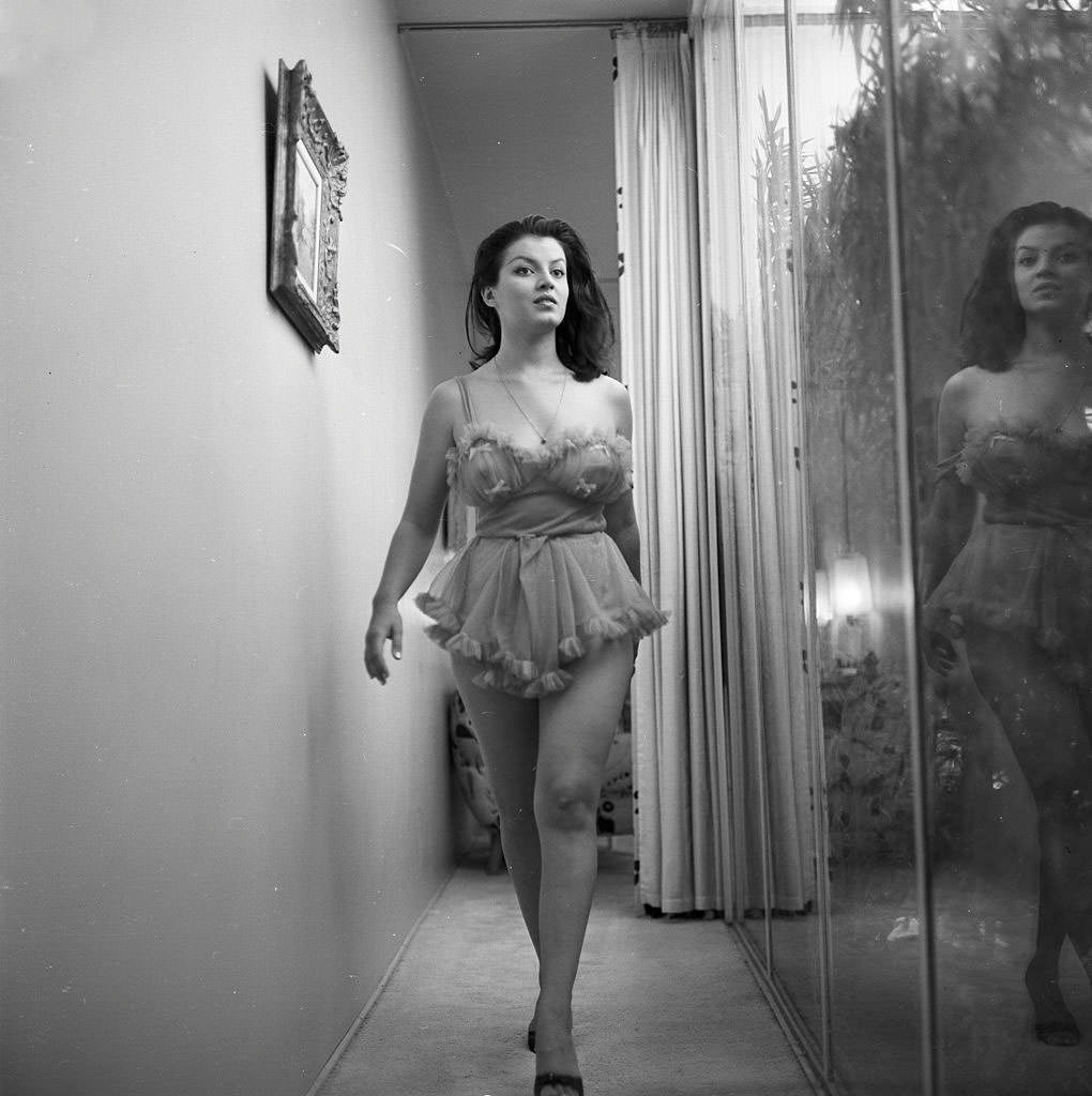 Joan Bradshaw walking during a photoshoot, 1960.