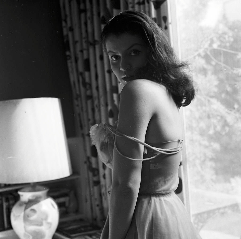 Joan Bradshaw posing for a fashion photoshoot, 1960
