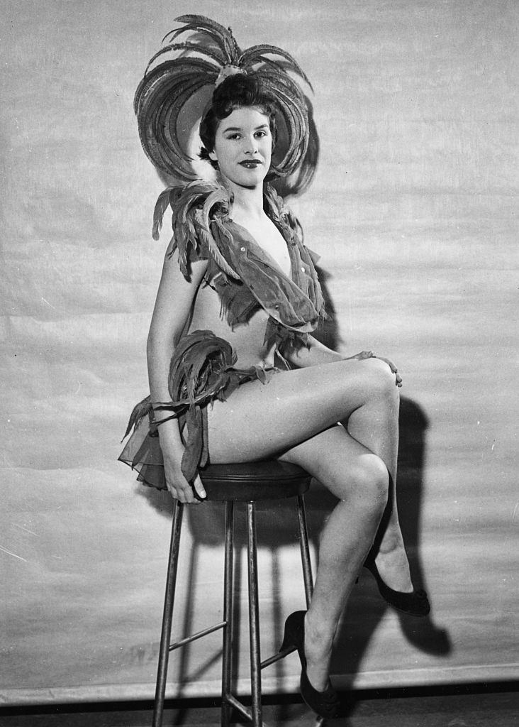 June Wilkinson wearing a feather showgirl costume, circa 1950