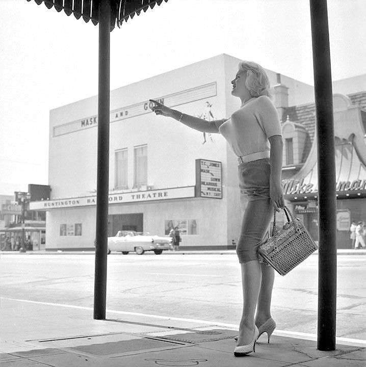 June Wilkinson in white shirt and bullet bra, 1958