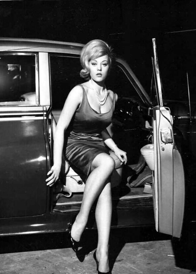 Margaret Nolan getting out of a car to attend a party