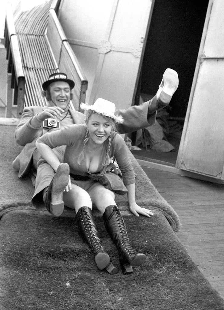 Margaret Nolan with Bernard Bresslaw during the filming of 'Carry On at Your Convenience', Brighton, 1971