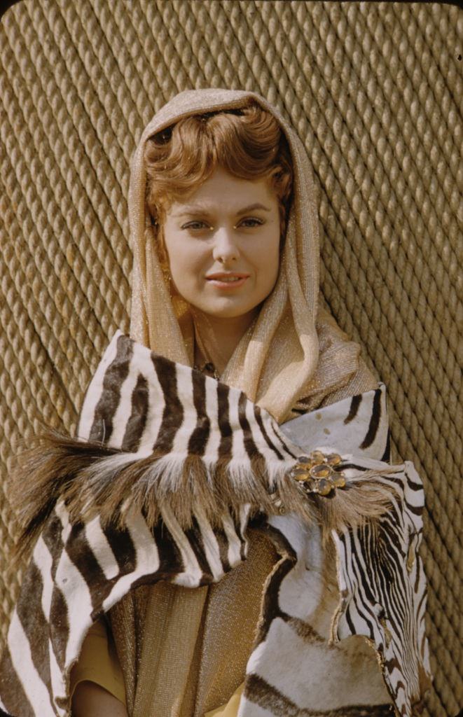Martha Hyer in a scarf and zebra print attire, 1959