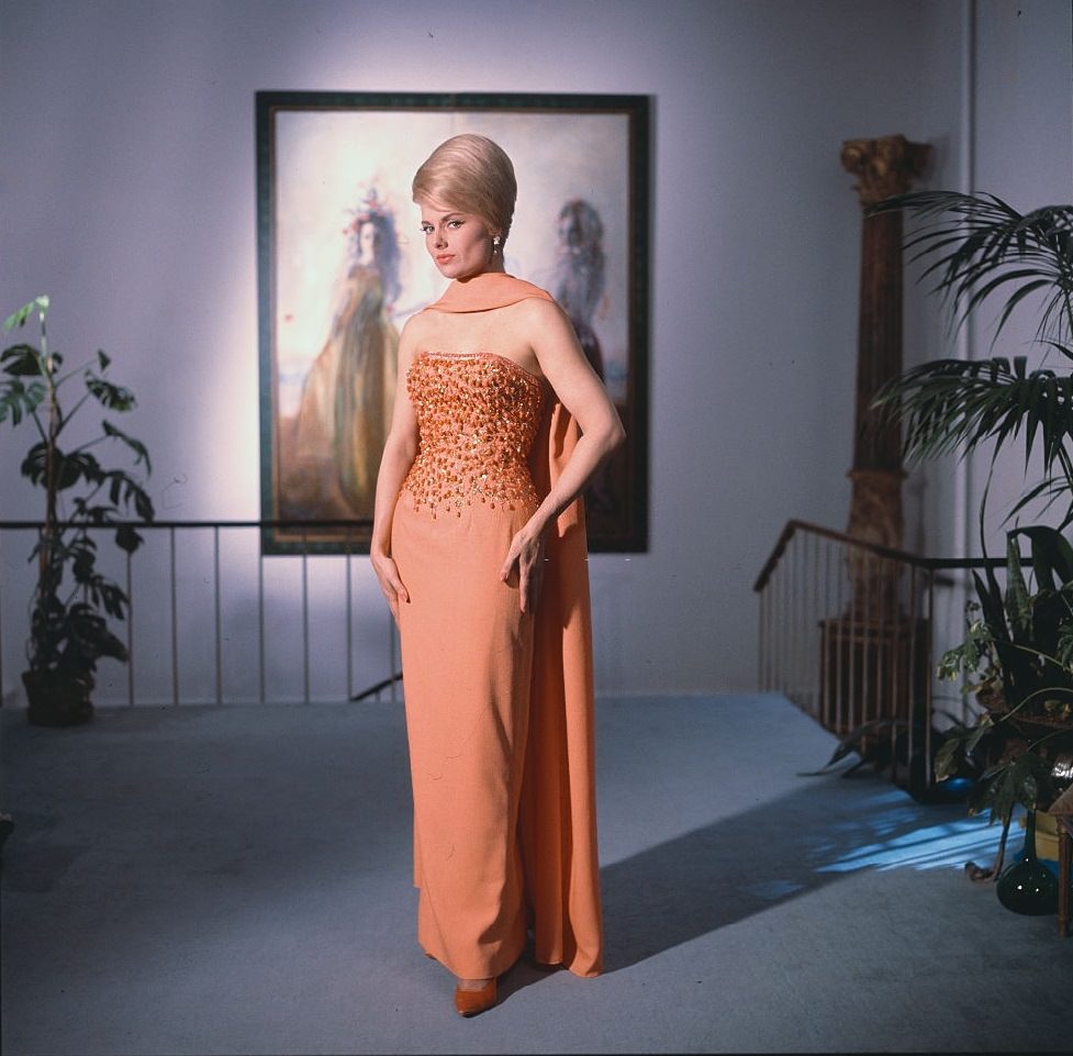 Actress Martha Hyer in an orange evening gown