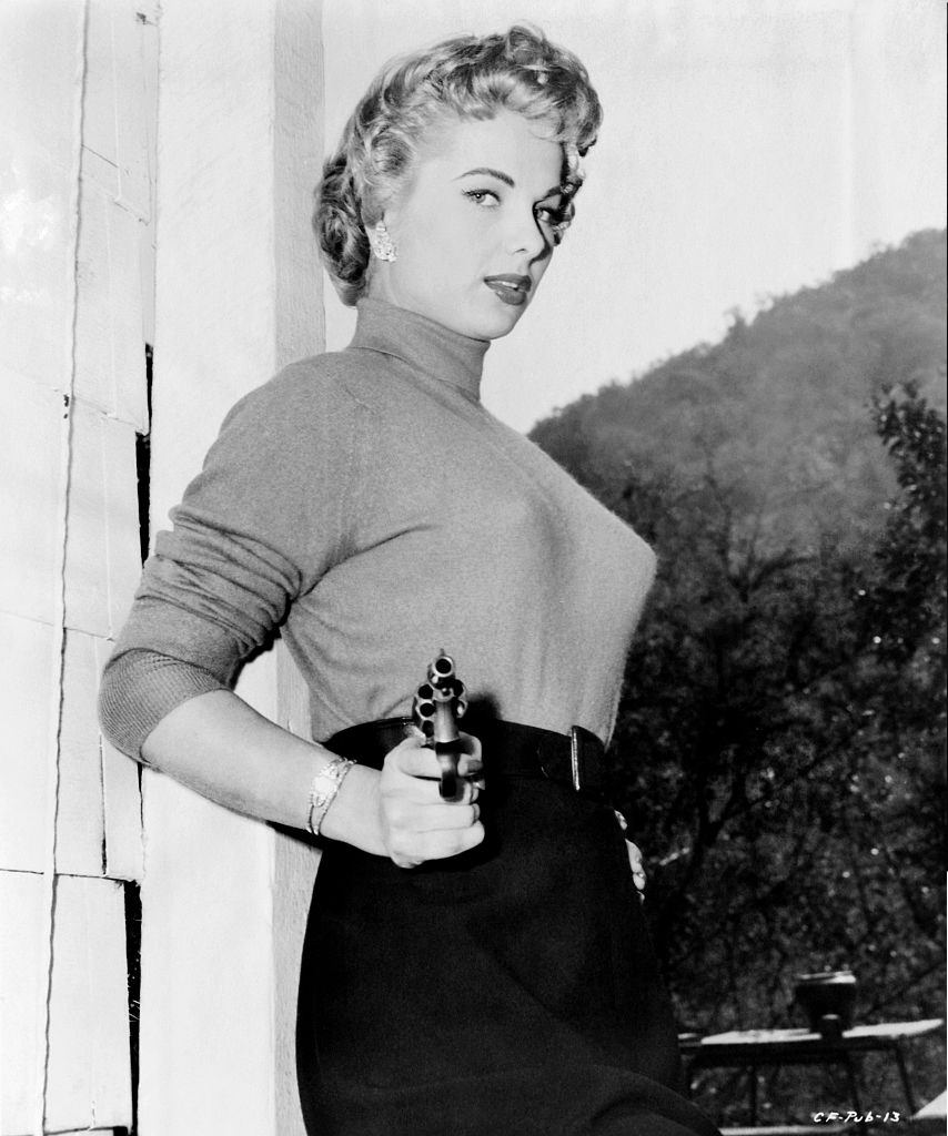 Martha Hyer point a revolver, 1952