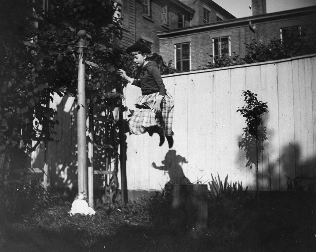 Zelma Levison jumps in the backyard of her home at 314 Livingston Street.June 19, 1886