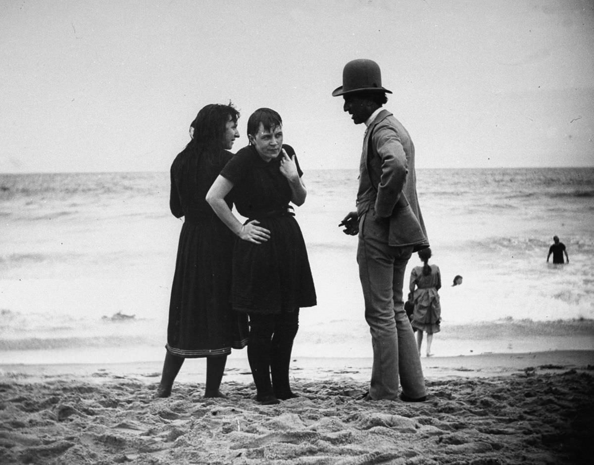 An actor talks with bathers on the beach.Aug. 24, 1886