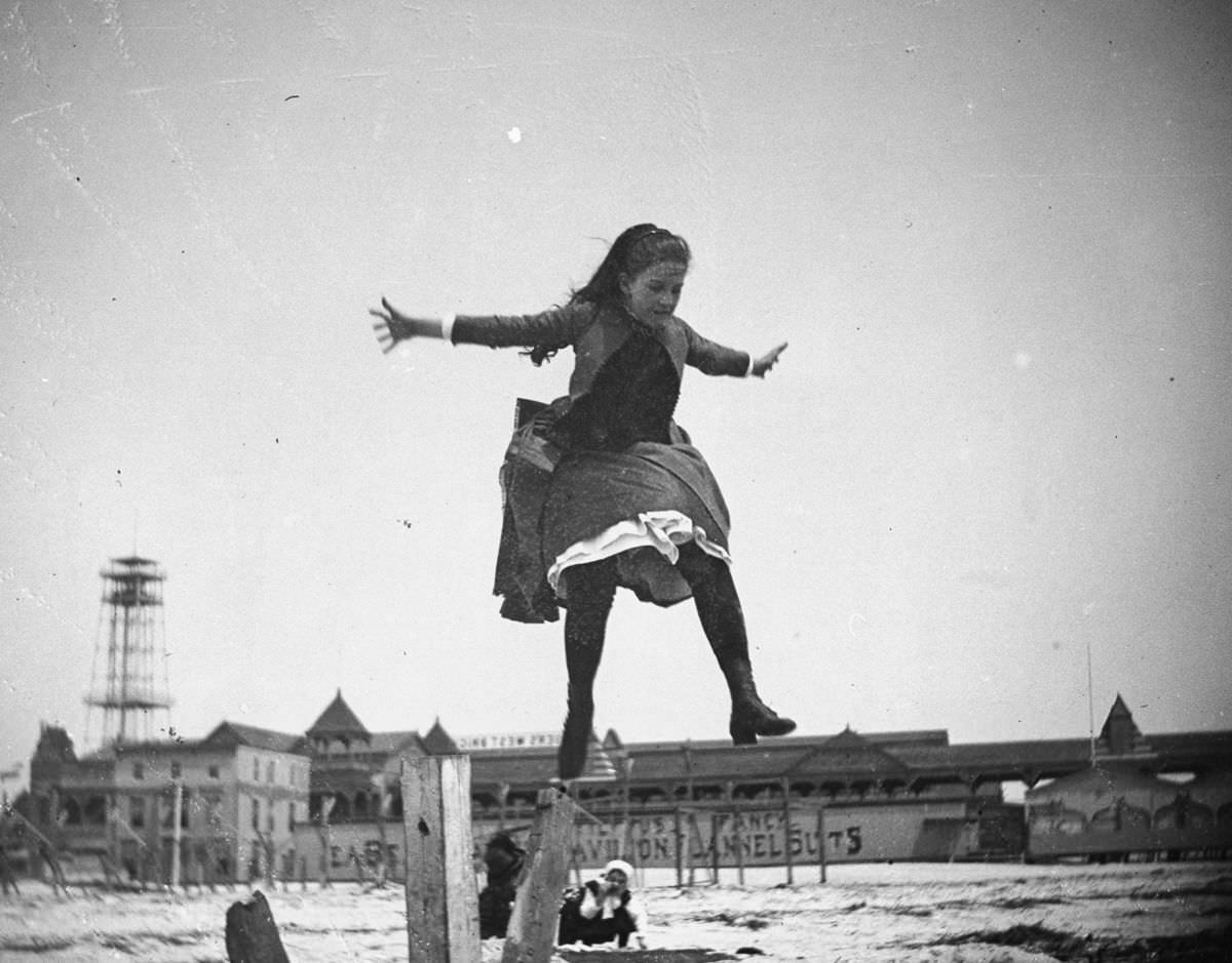 Edith Poey jumps off a wooden pole onto the sand at Coney Island.May 15, 1887