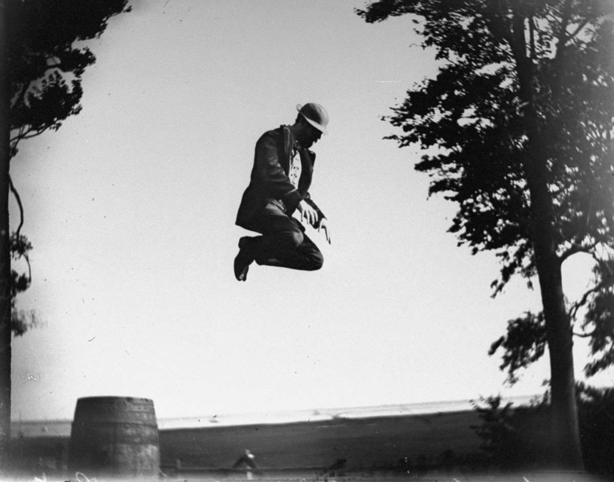 Edgar J. Taylor jumps off a barrel.June 24, 1887