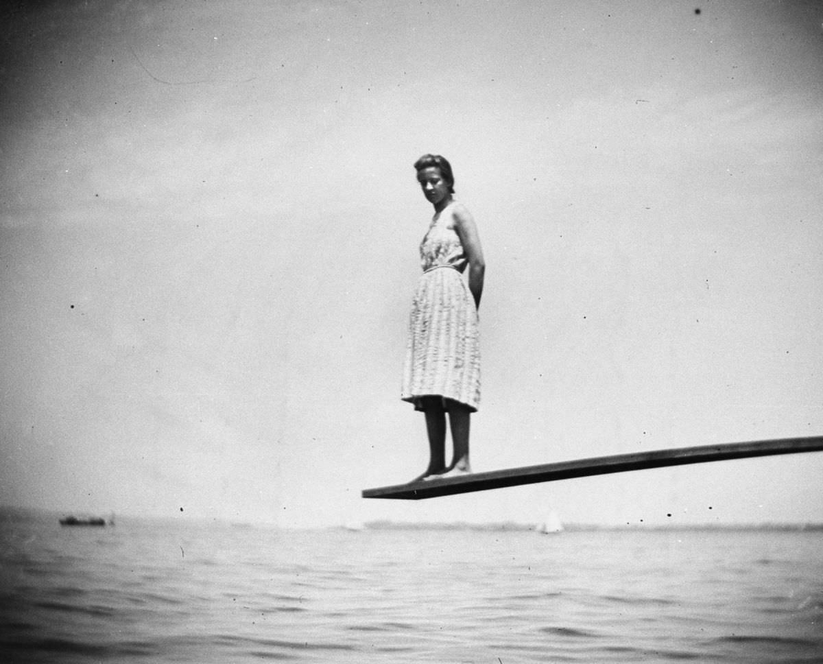 Maggie Ward stands on the end of a diving board at Coney Island.July 24, 1888