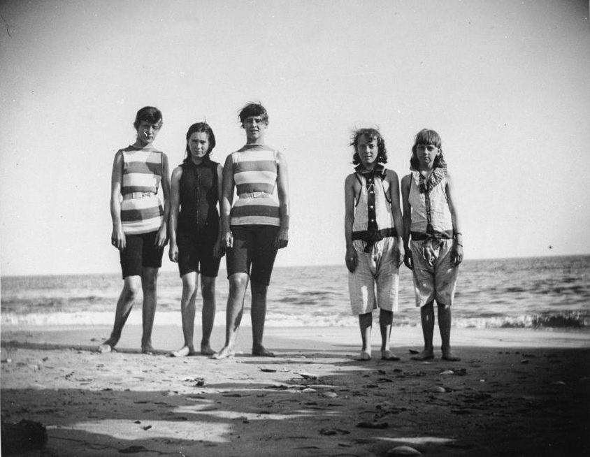 Five girls who will be competing in a swimming match posing by the shoreline at Coney Island, Brooklyn, NY, 1887