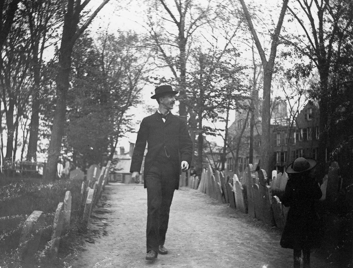 Nathan Abbott and a young girl walk through Copps Hill Cemetery.May 10, 1886