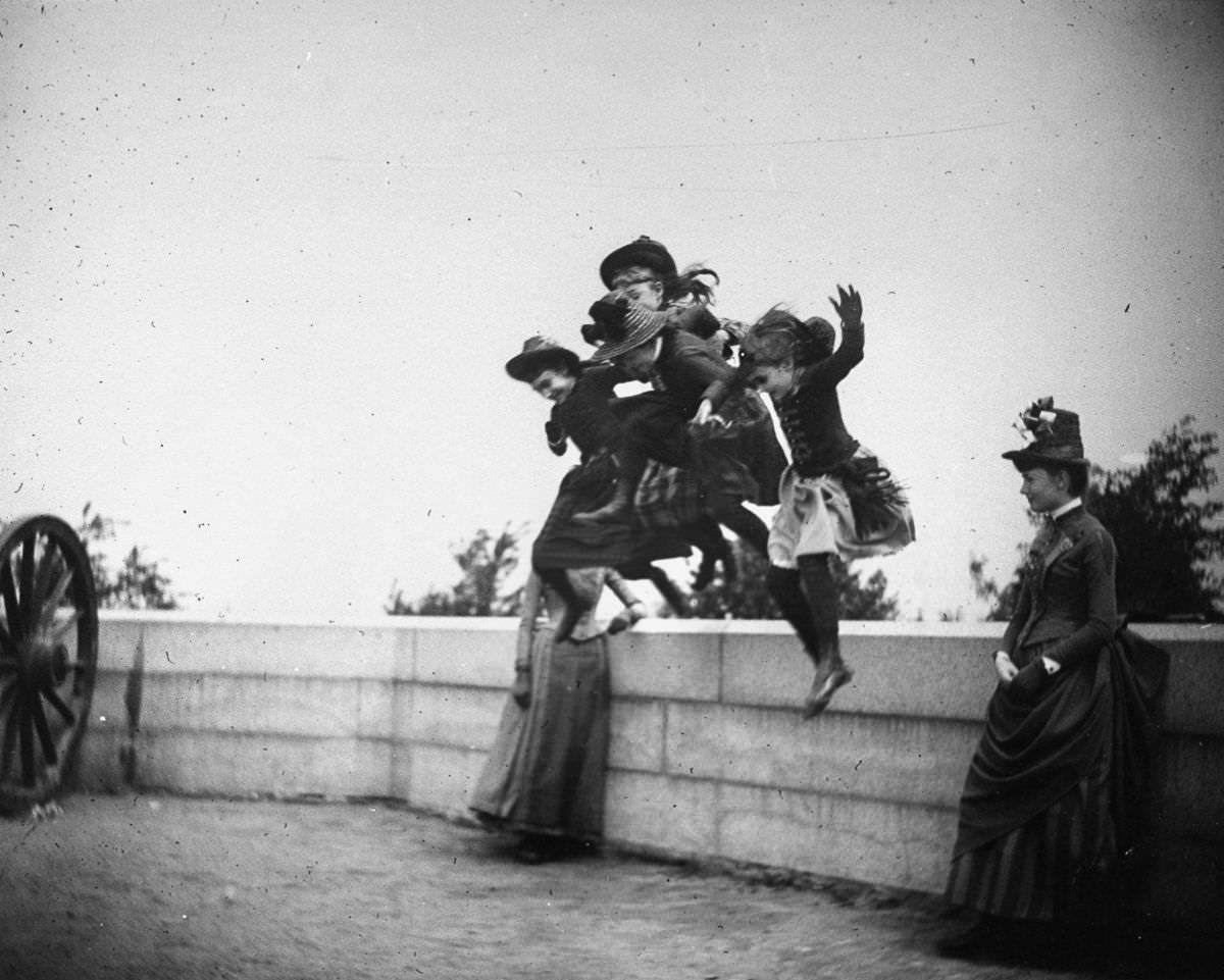 Girls jump off a stone wall in Fort Greene.May 22, 1886