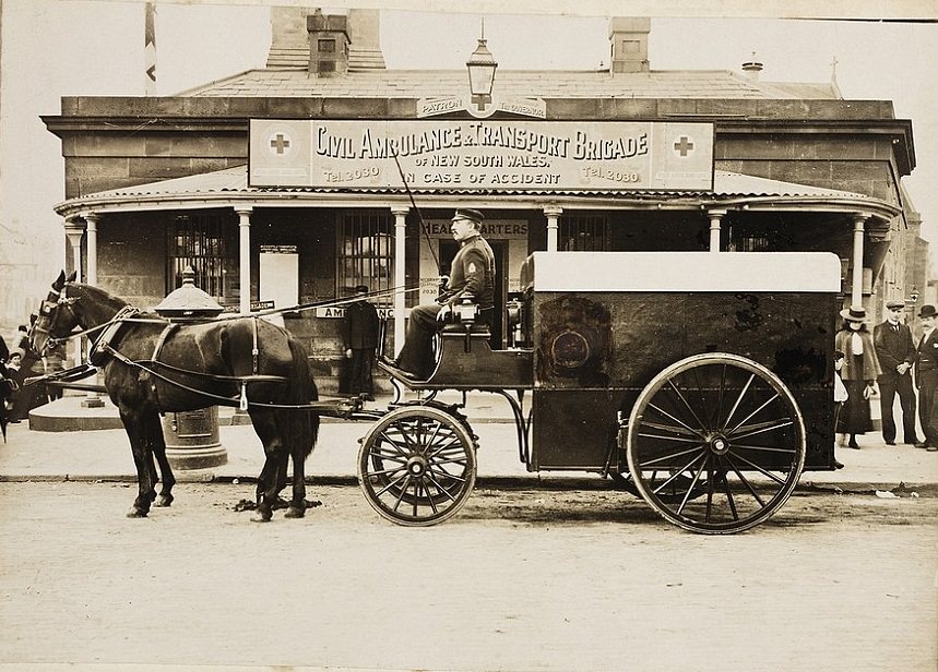 A police officer in a horse and cart outside the Civil Ambulance and Transport Brigade on the corner of George and Pitt Street in 1900.