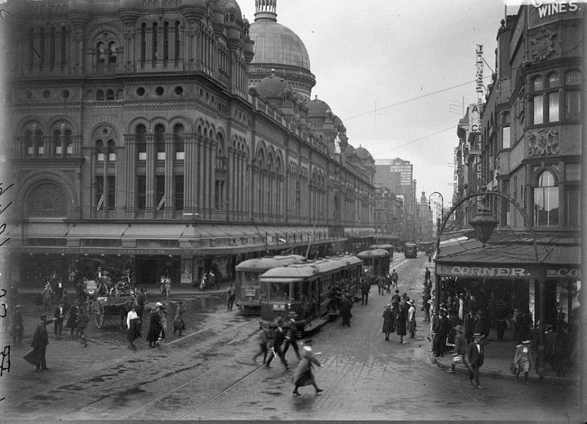 The Queen Victoria Building and n George Street with trams running through the centre, circa 1920