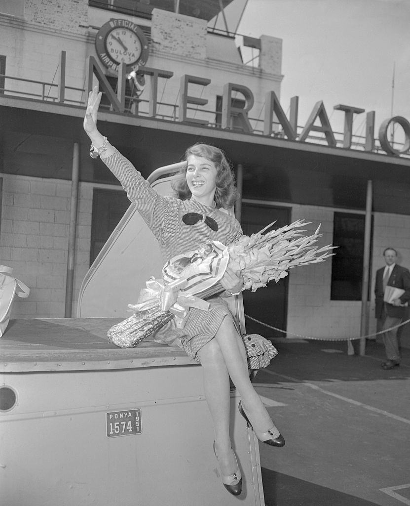 19-year-old Pier Angeli waves at Idlewild Airport on her arrival in New York from Germany.