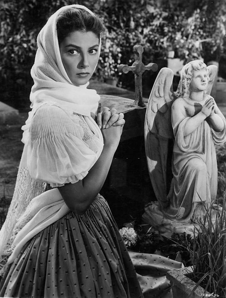Pier Angeli kneeling before religious statue in a scene from the film 'Sombrero', 1953