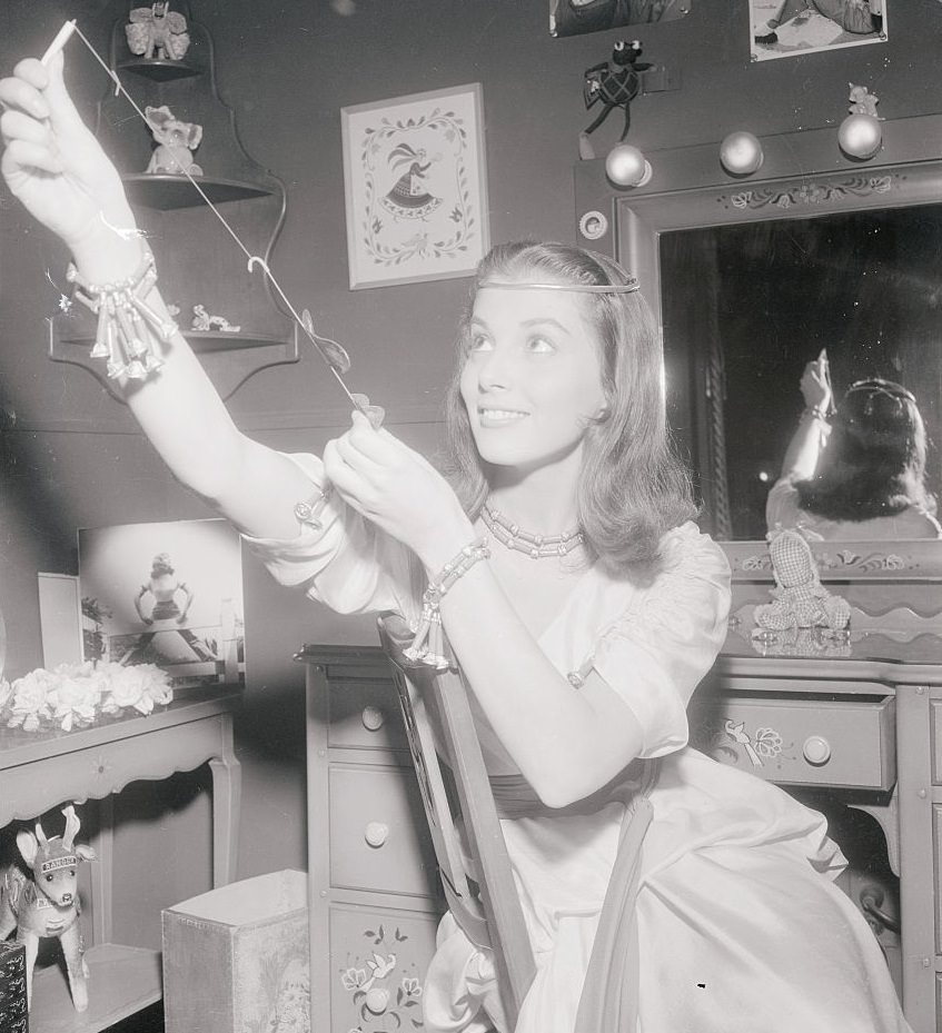 Pier Angeli tries out a model airplane given her by the cast of The Silver Chalice, 1954