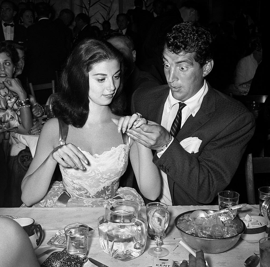 Pier Angeli shows off her engagement ring to a wide-eyed Dean Martin in 1955