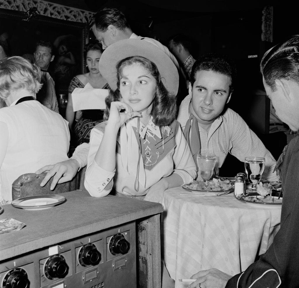 Pier Angeli with Alan Pearl dressed in western attire at a party, circa 1955