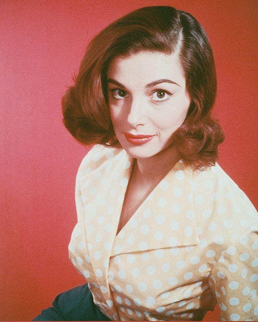 Pier Angeli wearing a peach blouse with white polka dots, 1960