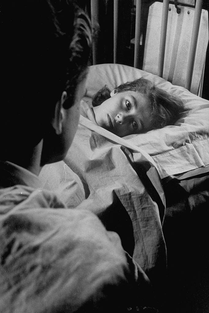 Pier Angeli lying in hospital bed, 1950