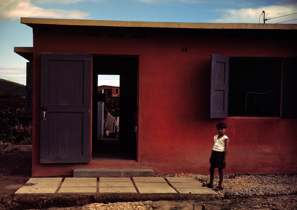 Child of a Farm Security Administration rural rehabilitation borrower in front of his house in Puerto Rico, December 1941