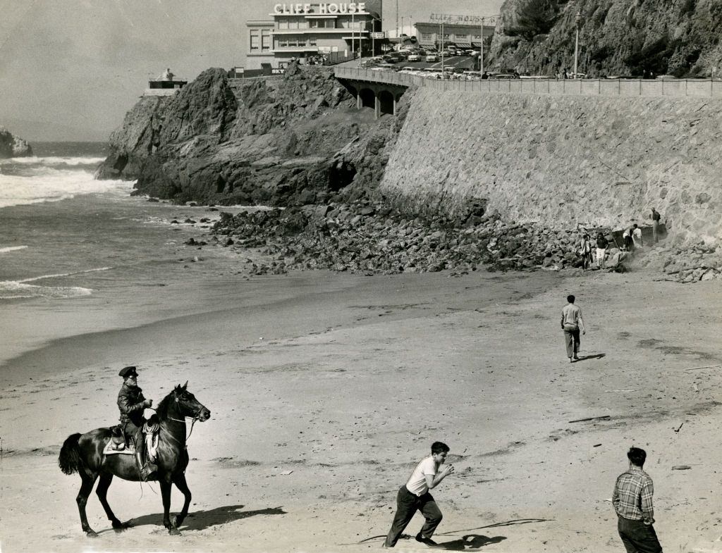 A policeman galloped about the beach chasing bold young men at the Cliff House, 1957