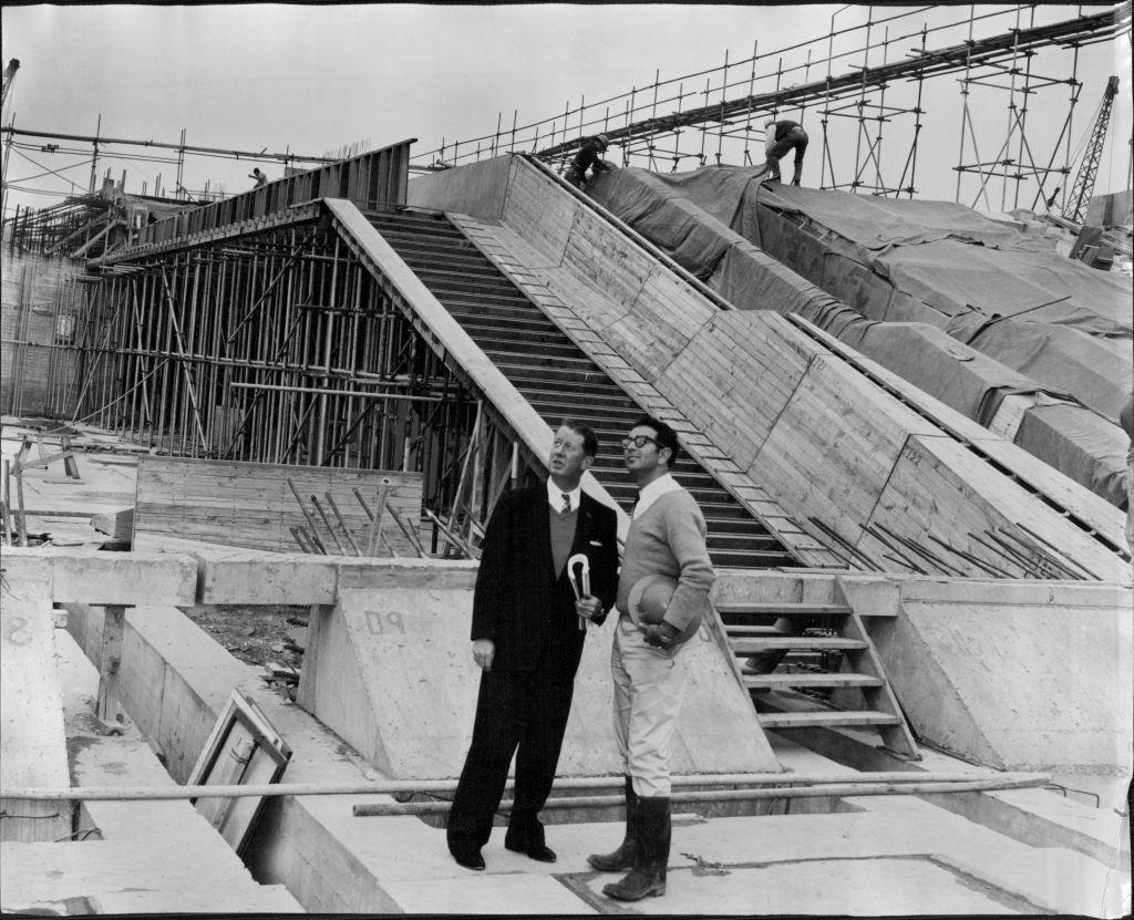 Mr. R. J. Thomsonand Mr. A. Levy, resident engineer, with the concourse behind them.