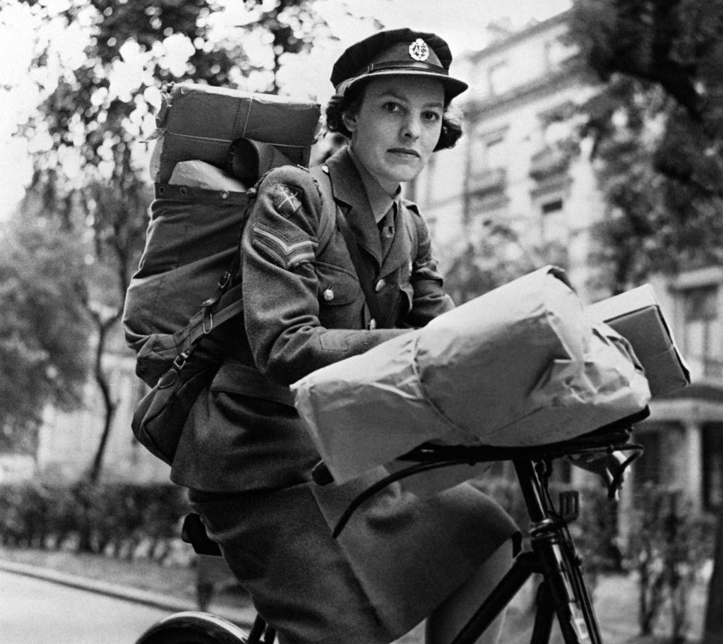 Members of the Women's Auxiliary Air Force (WAAF) carrying aircraft machine guns