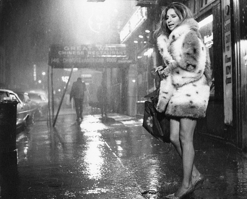 Barbra Streisand,on the street under a violent rain. USA, 1972.