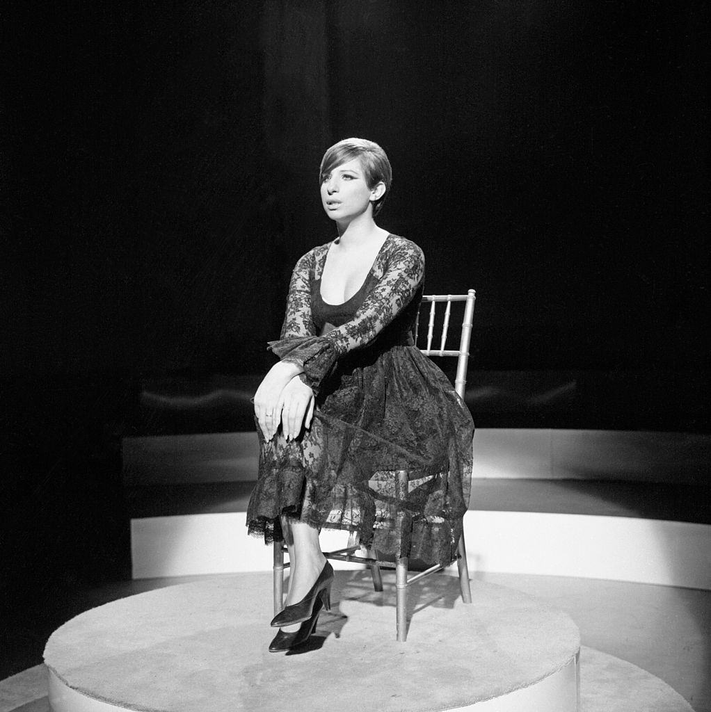 Barbra Streisand sitting on a stage before performing, 1965